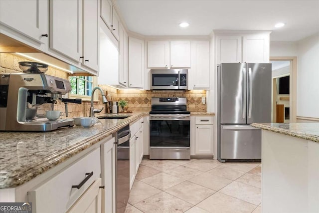 11785 Mountain Laurel Dr, Roswell, GA 30075 - kitchen with stainless steel appliances, a sink, decorative backsplash, white cabinetry, and light stone counters