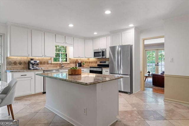 11785 Mountain Laurel Dr, Roswell, GA 30075 - kitchen with appliances with stainless steel finishes, white cabinetry, stone counters, tasteful backsplash, and recessed lighting