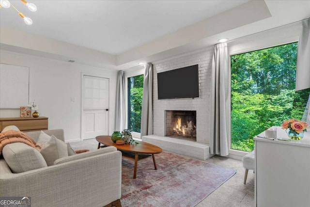 11785 Mountain Laurel Dr, Roswell, GA 30075 - living area with light carpet, a brick fireplace, and a raised ceiling