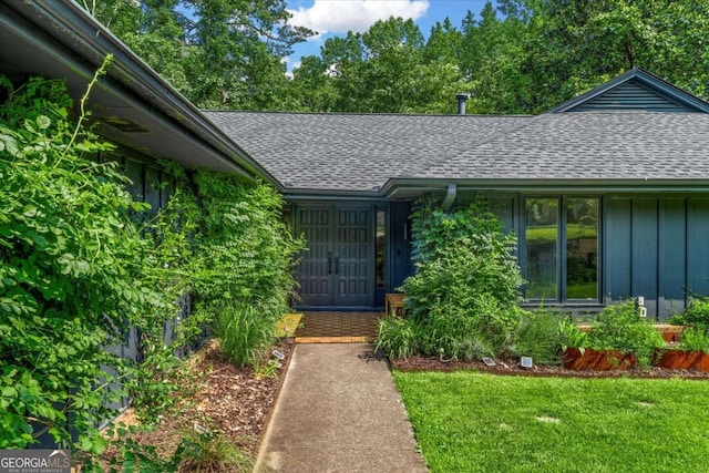 11785 Mountain Laurel Dr, Roswell, GA 30075 - entrance to property with a shingled roof, board and batten siding, a lawn, and french doors