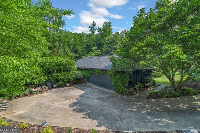 11785 Mountain Laurel Dr, Roswell, GA 30075 - view of home's exterior featuring a garage and roof with shingles