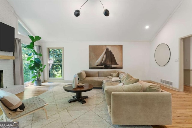 11785 Mountain Laurel Dr, Roswell, GA 30075 - living room with light wood-style floors, a brick fireplace, ornamental molding, lofted ceiling, and recessed lighting