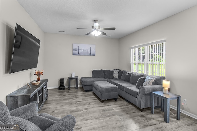 229 Wellspring Ter, Allenhurst, GA 31301 - living area featuring ceiling fan, wood finished floors, baseboards, and a textured ceiling
