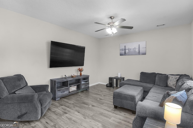 229 Wellspring Ter, Allenhurst, GA 31301 - living room featuring a ceiling fan, wood finished floors, and baseboards