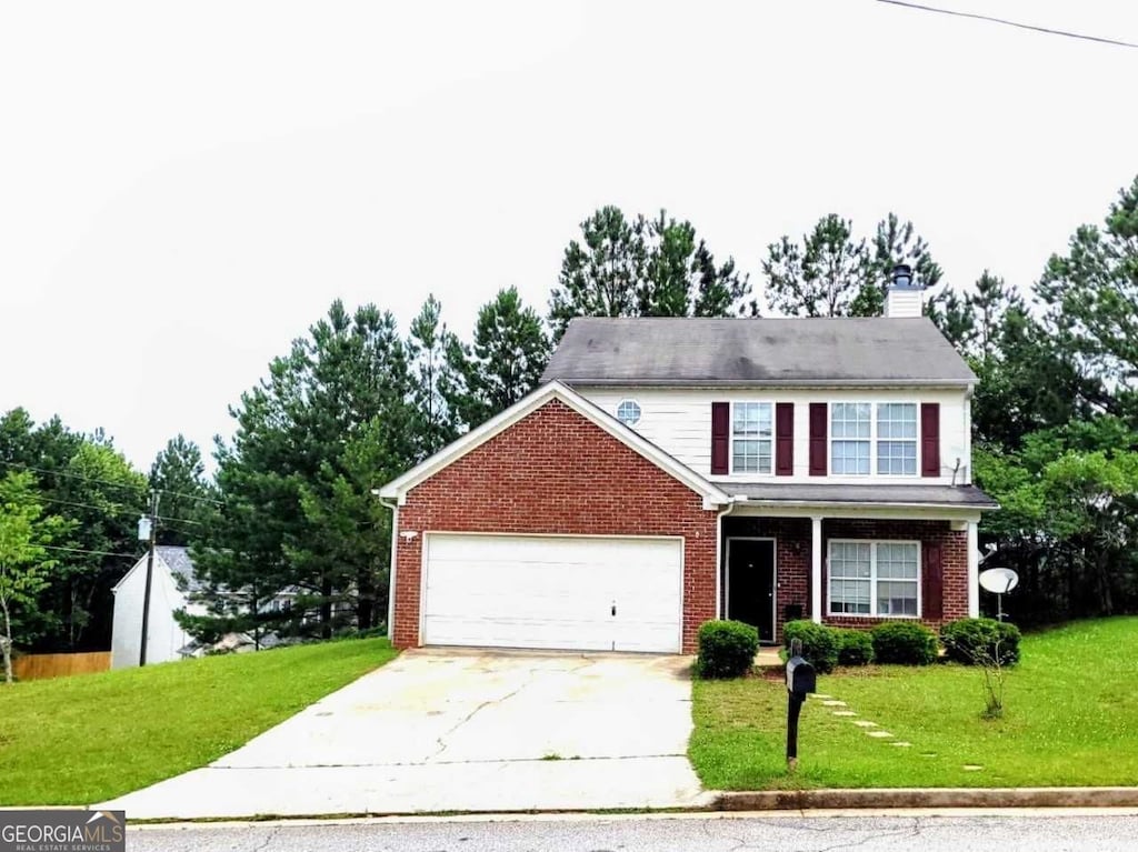 6902 Malvern Ct, Stonecrest, GA 30038 - traditional-style home with concrete driveway, a front yard, brick siding, and a chimney