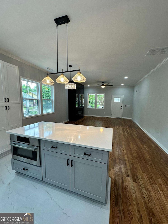 1766 W Lyle Ave, College Park, GA 30337 - kitchen featuring gray cabinetry, stainless steel oven, ornamental molding, a ceiling fan, and light countertops
