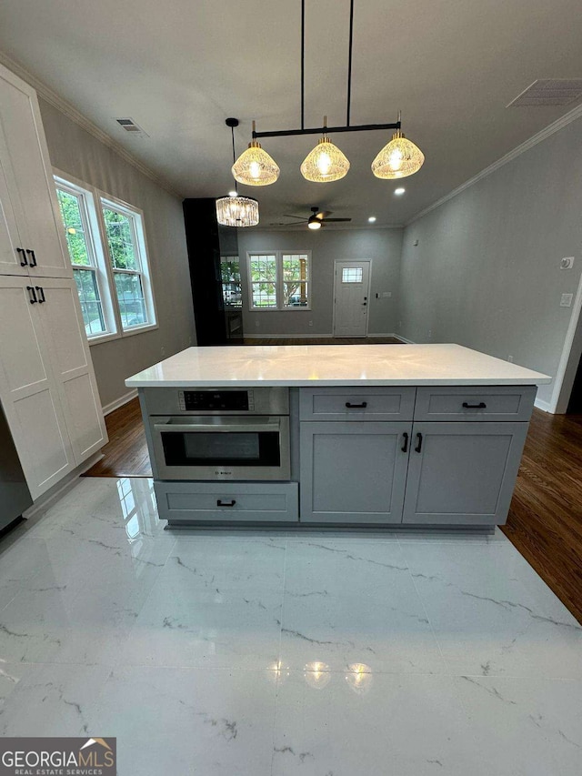 1766 W Lyle Ave, College Park, GA 30337 - kitchen featuring oven, gray cabinetry, crown molding, ceiling fan, and pendant lighting