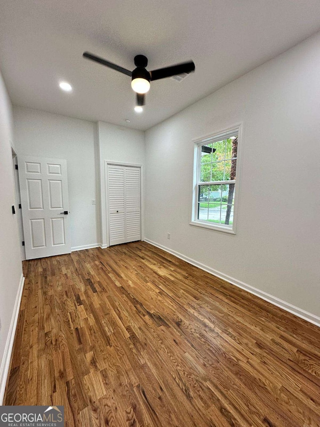 1766 W Lyle Ave, College Park, GA 30337 - unfurnished bedroom featuring wood finished floors, baseboards, a closet, ceiling fan, and recessed lighting