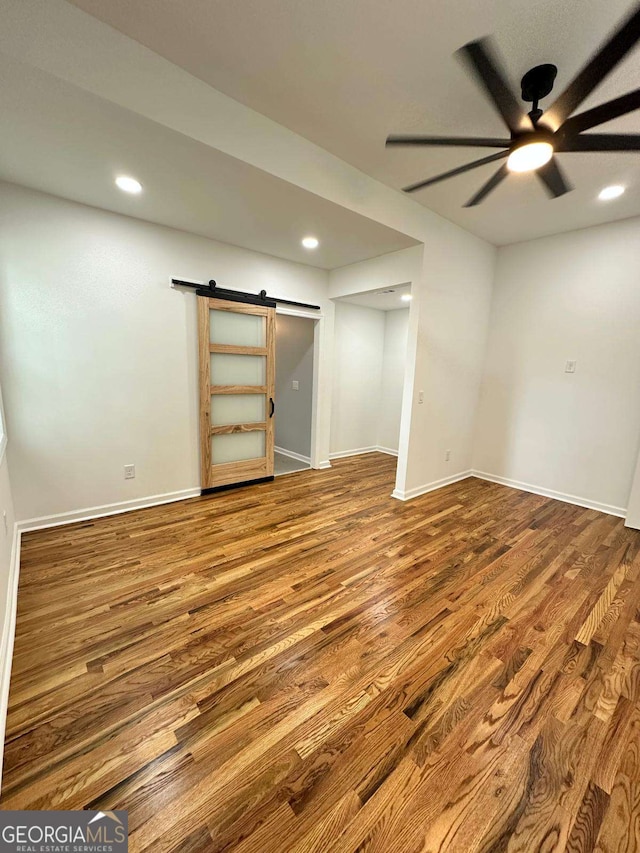1766 W Lyle Ave, College Park, GA 30337 - below grade area with a barn door, wood finished floors, ceiling fan, baseboards, and recessed lighting