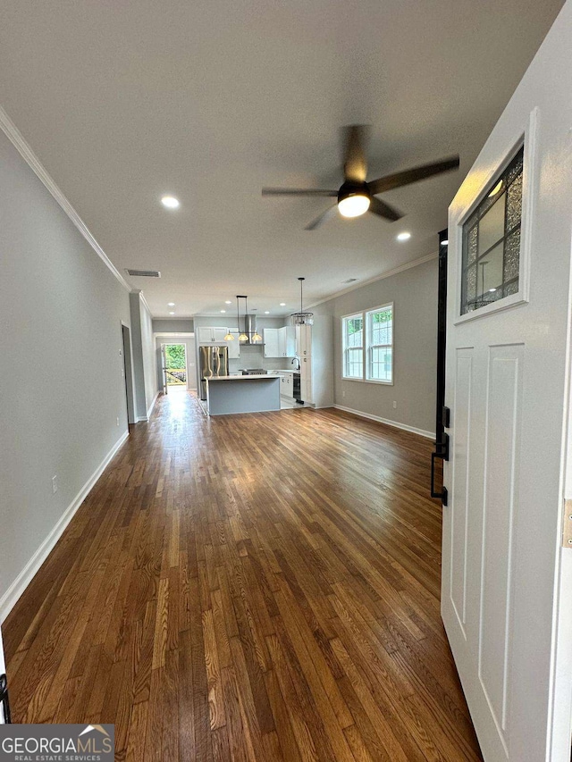 1766 W Lyle Ave, College Park, GA 30337 - unfurnished living room with crown molding, a ceiling fan, dark wood-type flooring, baseboards, and recessed lighting