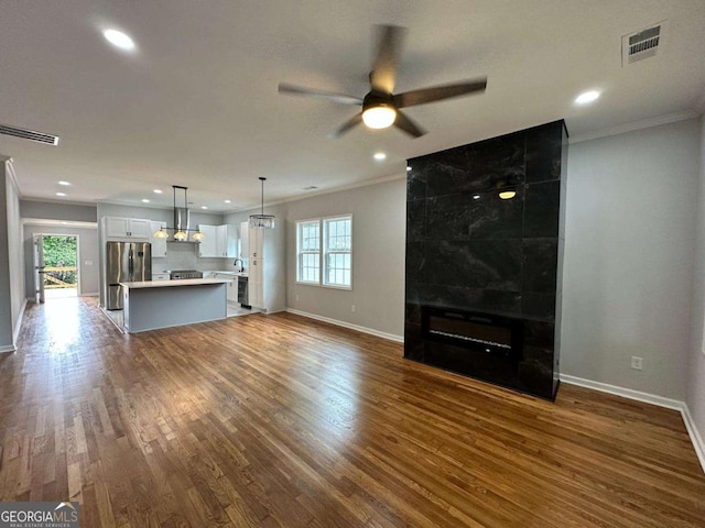1766 W Lyle Ave, College Park, GA 30337 - unfurnished living room with crown molding, baseboards, ceiling fan, dark wood finished floors, and recessed lighting