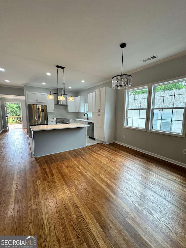 1766 W Lyle Ave, College Park, GA 30337 - kitchen with appliances with stainless steel finishes, light countertops, a chandelier, healthy amount of natural light, and crown molding