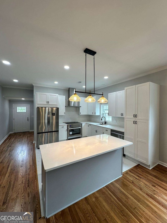 1766 W Lyle Ave, College Park, GA 30337 - kitchen with stainless steel appliances, wall chimney range hood, a sink, light countertops, and a center island