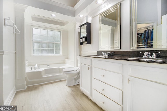 40 Briarwood Ln, Newnan, GA 30265 - bathroom with ornamental molding, double vanity, a bath, wood finished floors, and toilet