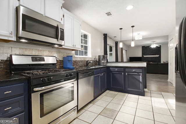 40 Briarwood Ln, Newnan, GA 30265 - kitchen with appliances with stainless steel finishes, a sink, white cabinets, open floor plan, and ceiling fan