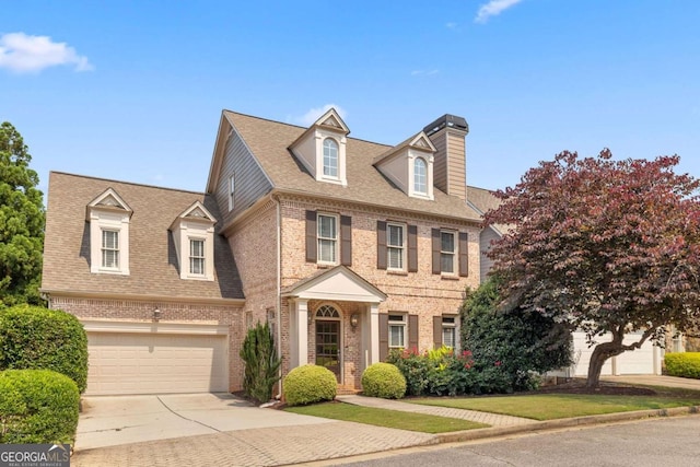 1121 Vinings Grove Way SE, Smyrna, GA 30082 - view of front of property featuring brick siding, a garage, driveway, a chimney, and a shingled roof