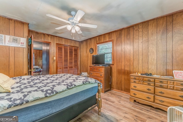 308 E 20th St SW, Rome, GA 30161 - bedroom featuring light wood-style floors, wooden walls, multiple closets, and ceiling fan