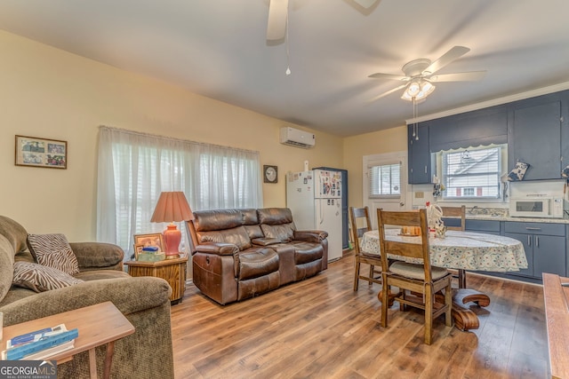 308 E 20th St SW, Rome, GA 30161 - living area featuring a ceiling fan, a wall mounted air conditioner, and wood finished floors