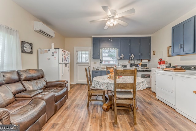 308 E 20th St SW, Rome, GA 30161 - dining area featuring a wall mounted AC, a ceiling fan, separate washer and dryer, and light wood-type flooring