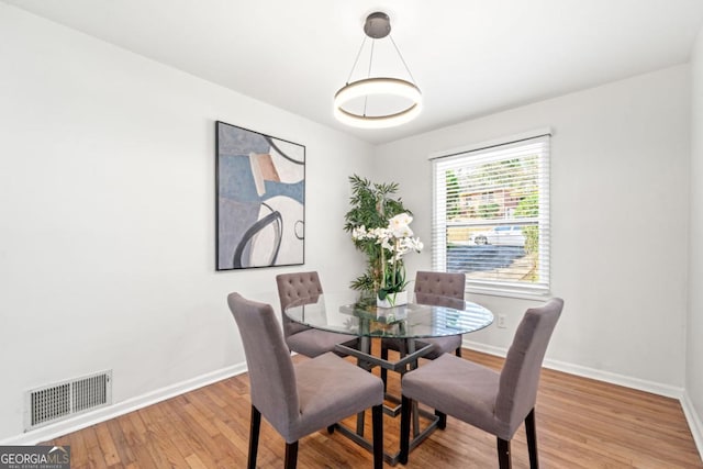 801 N Evelyn Pl NW, Atlanta, GA 30318 - dining room featuring baseboards and wood finished floors