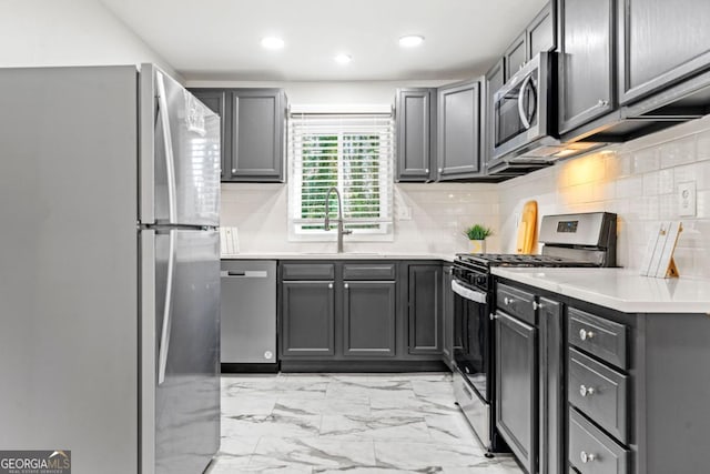 801 N Evelyn Pl NW, Atlanta, GA 30318 - kitchen featuring stainless steel appliances, decorative backsplash, gray cabinets, light countertops, and recessed lighting