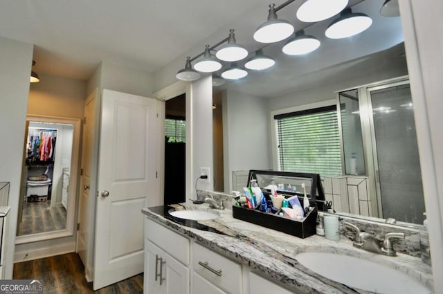 1040 Matthew Ln, Madison, GA 30650 - bathroom with double vanity, wood finished floors, and a stall shower
