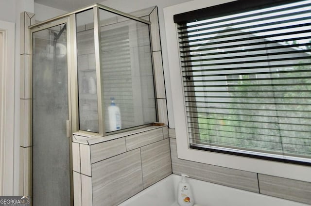 1040 Matthew Ln, Madison, GA 30650 - bathroom with a garden tub, a stall shower, and plenty of natural light