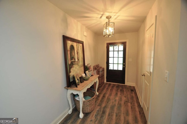 1040 Matthew Ln, Madison, GA 30650 - doorway with a chandelier, dark wood-style floors, and baseboards