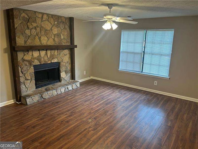 3674 Riverchase Ter, Decatur, GA 30034 - unfurnished living room with wood finished floors, a textured ceiling, baseboards, ceiling fan, and a fireplace