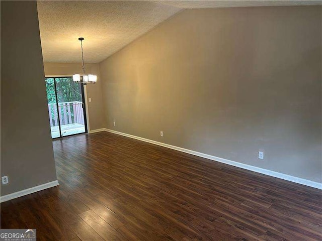 3674 Riverchase Ter, Decatur, GA 30034 - unfurnished room with a chandelier, dark wood-type flooring, baseboards, vaulted ceiling, and a textured ceiling