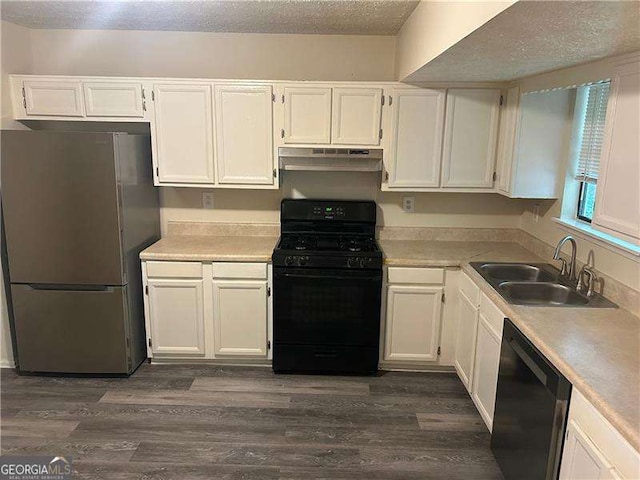 3674 Riverchase Ter, Decatur, GA 30034 - kitchen with gas stove, freestanding refrigerator, dishwasher, under cabinet range hood, and a sink