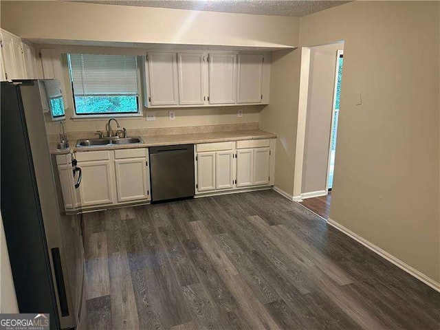 3674 Riverchase Ter, Decatur, GA 30034 - kitchen with stainless steel dishwasher, a sink, freestanding refrigerator, white cabinets, and dark wood-type flooring