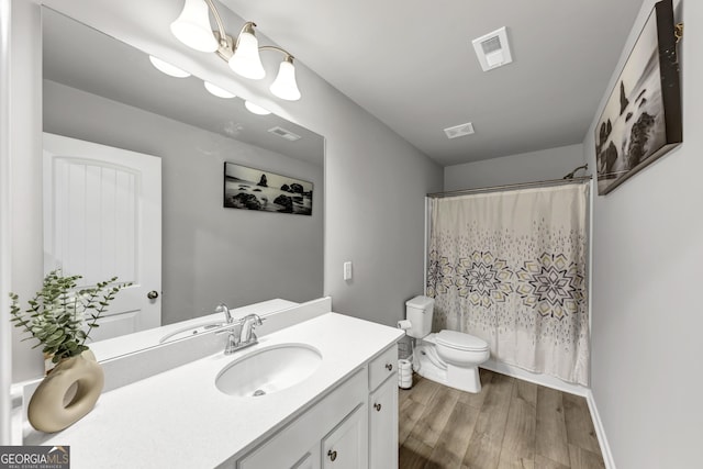 2037 Cedar Grove Rd, Conley, GA 30288 - bathroom featuring toilet, wood finished floors, vanity, curtained shower, and baseboards