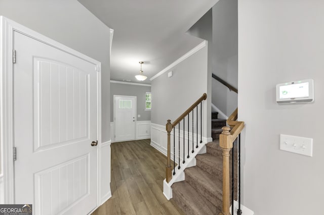 2037 Cedar Grove Rd, Conley, GA 30288 - foyer entrance with crown molding, wood finished floors, stairs, and a wainscoted wall