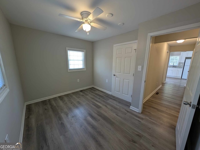 809 S 9th St, Griffin, GA 30224 - unfurnished bedroom featuring baseboards, dark wood-style flooring, and a ceiling fan