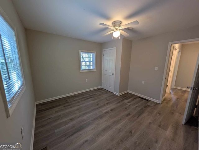 809 S 9th St, Griffin, GA 30224 - unfurnished bedroom with dark wood-type flooring, baseboards, a ceiling fan, and a closet