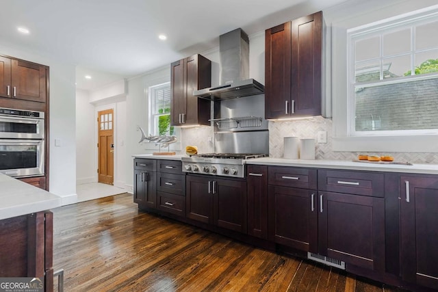 937 Rosedale Rd NE, Atlanta, GA 30306 - kitchen with wall chimney exhaust hood, stainless steel appliances, dark wood finished floors, light countertops, and backsplash
