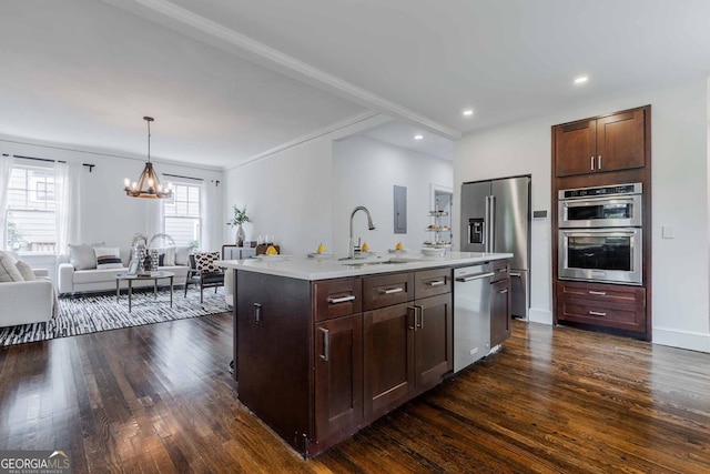 937 Rosedale Rd NE, Atlanta, GA 30306 - kitchen featuring appliances with stainless steel finishes, open floor plan, a chandelier, dark wood-type flooring, and light countertops