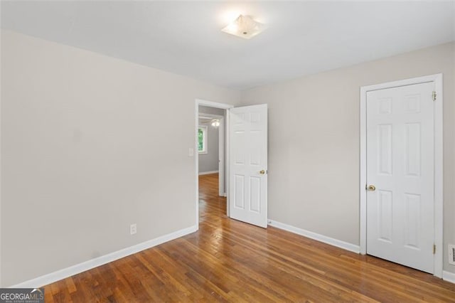 2358 Dabney Ter, East Point, GA 30344 - unfurnished bedroom with baseboards and wood finished floors