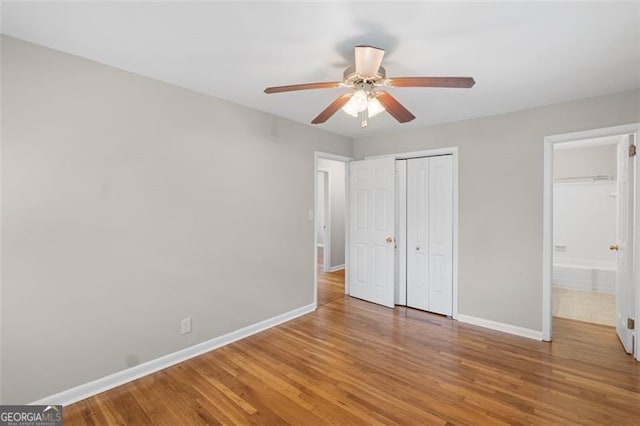 2358 Dabney Ter, East Point, GA 30344 - unfurnished bedroom with baseboards, wood finished floors, and a closet