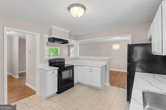 2358 Dabney Ter, East Point, GA 30344 - kitchen featuring black range with electric cooktop, custom exhaust hood, a peninsula, white cabinets, and freestanding refrigerator