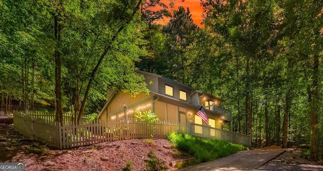 223 Mango Cir, Ellijay, GA 30540 - view of property exterior featuring a fenced front yard, a balcony, and a wooded view