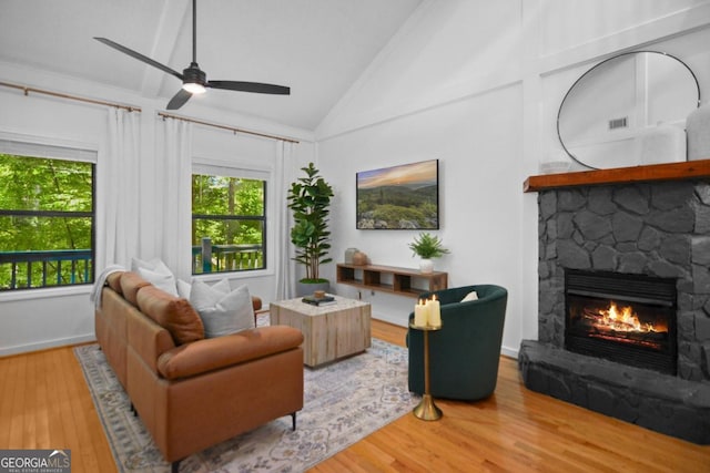 223 Mango Cir, Ellijay, GA 30540 - living area with vaulted ceiling, a fireplace, wood finished floors, a ceiling fan, and baseboards