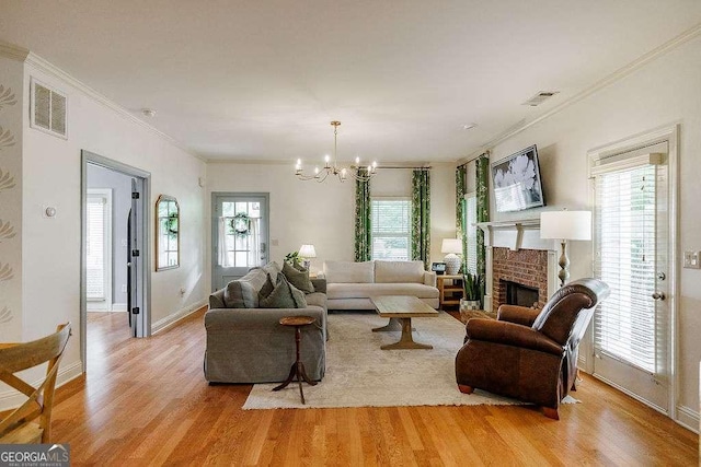 1901 Franklin Grove Pkwy, Bogart, GA 30622 - living area with light wood-type flooring, crown molding, a chandelier, a fireplace, and baseboards