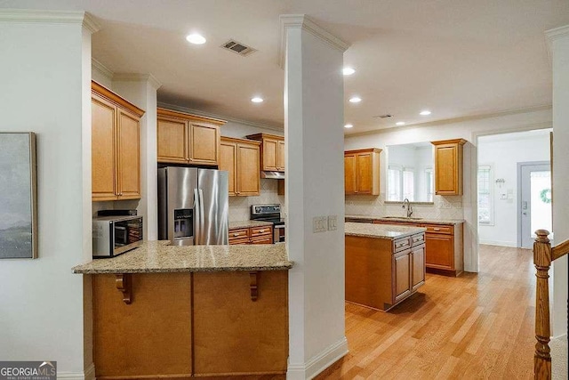 1901 Franklin Grove Pkwy, Bogart, GA 30622 - kitchen featuring stainless steel appliances, light stone countertops, backsplash, a sink, and ornamental molding