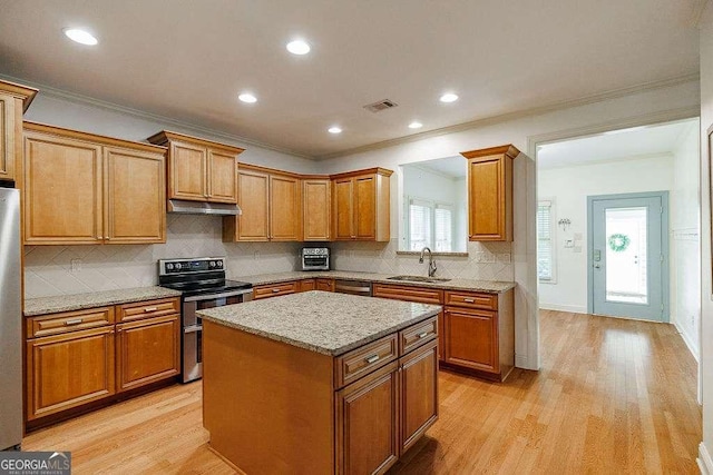1901 Franklin Grove Pkwy, Bogart, GA 30622 - kitchen featuring stainless steel appliances, a sink, under cabinet range hood, a kitchen island, and light wood finished floors