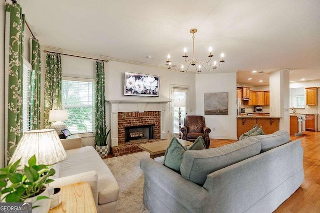 1901 Franklin Grove Pkwy, Bogart, GA 30622 - living room featuring a chandelier, a fireplace, ornamental molding, light wood-style floors, and recessed lighting