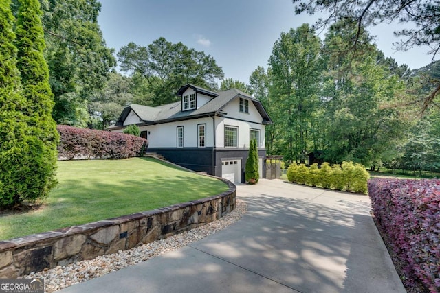 14440 Cogburn Rd, Alpharetta, GA 30004 - view of property exterior with driveway, a garage, stucco siding, and a lawn