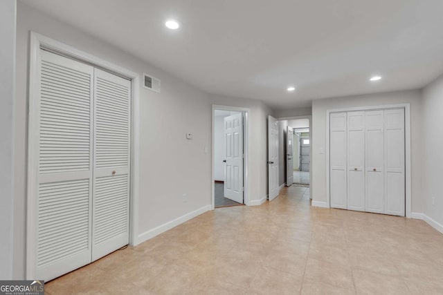14440 Cogburn Rd, Alpharetta, GA 30004 - unfurnished bedroom featuring recessed lighting, two closets, and baseboards