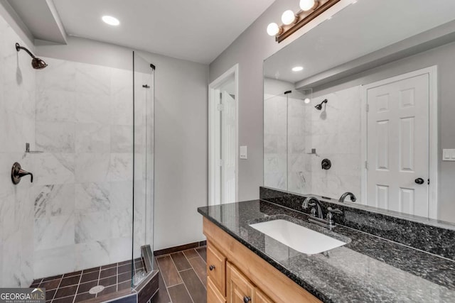 14440 Cogburn Rd, Alpharetta, GA 30004 - bathroom featuring a shower stall, vanity, baseboards, and recessed lighting